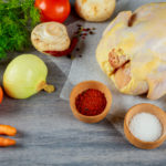 Set of products for making organic raw chicken on wood with fresh ingredients for broth